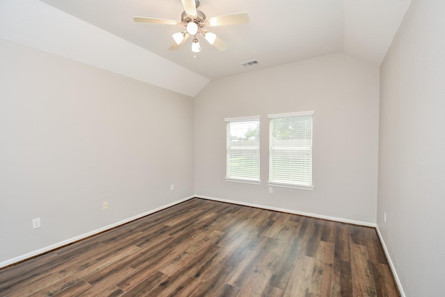 empty room featuring ceiling fan, dark wood-type flooring, and lofted ceiling