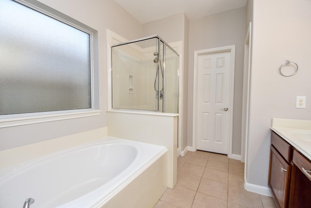 bathroom featuring tile patterned floors, vanity, and separate shower and tub