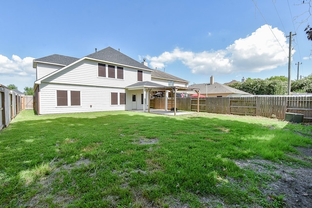 back of property featuring a yard and a patio