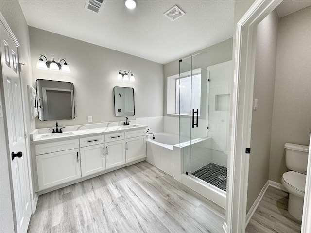 full bathroom with separate shower and tub, hardwood / wood-style floors, vanity, and toilet