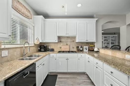 kitchen featuring tasteful backsplash, sink, dishwasher, white cabinets, and stainless steel gas stovetop