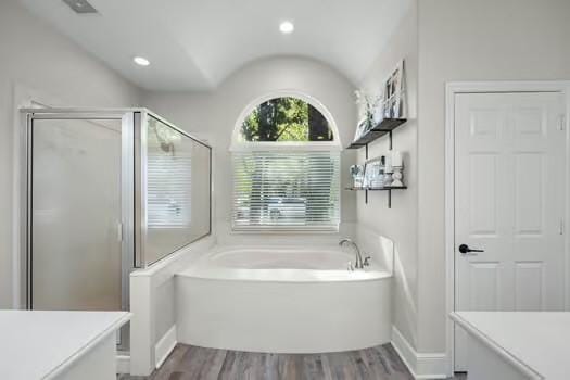 bathroom with hardwood / wood-style flooring, vanity, and shower with separate bathtub