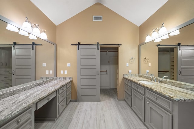 bathroom with vanity and lofted ceiling