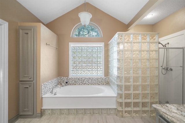 bathroom with vaulted ceiling and shower with separate bathtub