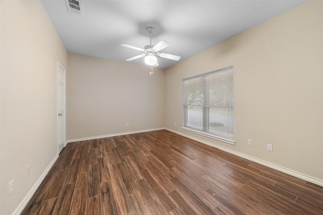 empty room with ceiling fan and dark hardwood / wood-style floors