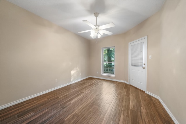 empty room featuring dark hardwood / wood-style flooring and ceiling fan