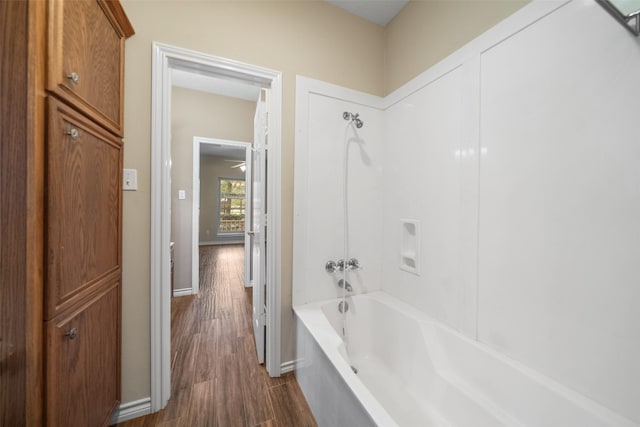 bathroom featuring bathtub / shower combination and hardwood / wood-style flooring