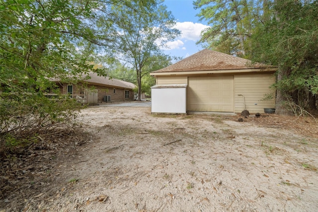 view of side of home featuring an outdoor structure