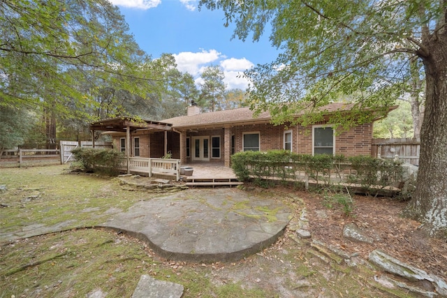 rear view of property with a wooden deck