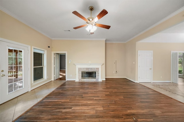 unfurnished living room with ceiling fan, a fireplace, dark hardwood / wood-style floors, and ornamental molding