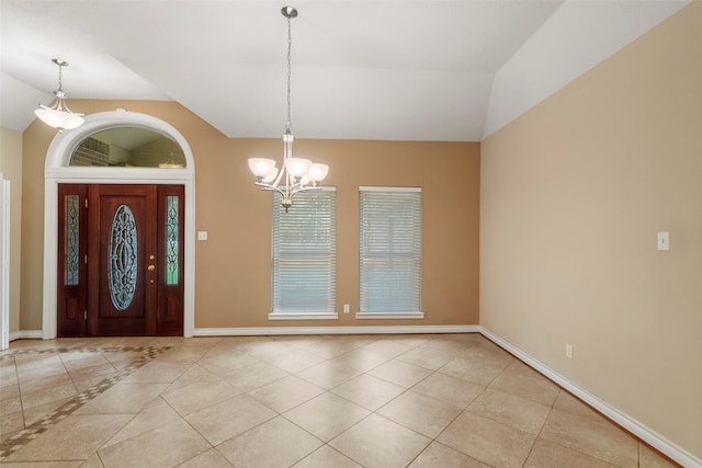 entryway featuring light tile patterned flooring, lofted ceiling, and a notable chandelier