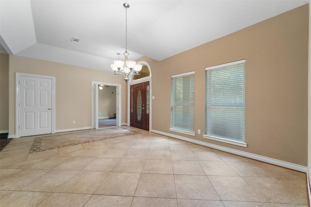 interior space with ceiling fan with notable chandelier, a raised ceiling, and vaulted ceiling