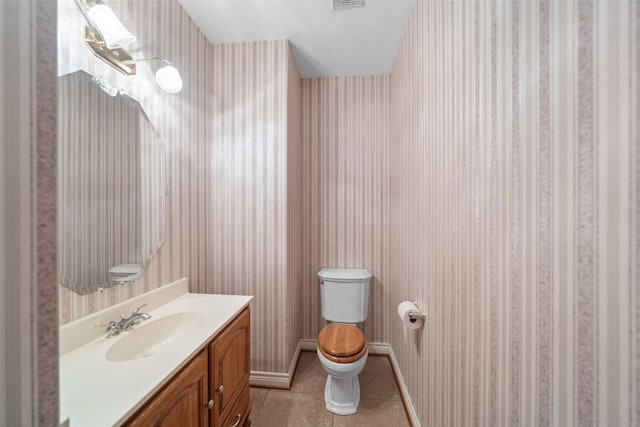 bathroom featuring tile patterned floors, vanity, and toilet