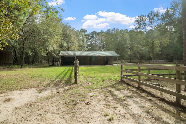 view of yard featuring an outbuilding and a rural view