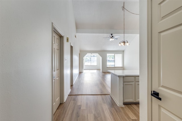 hall featuring a notable chandelier and light hardwood / wood-style floors