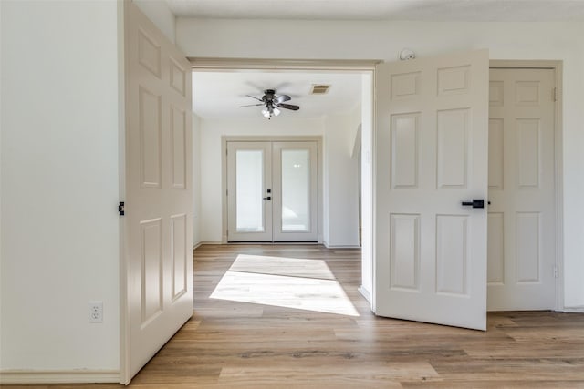 foyer featuring ceiling fan, light hardwood / wood-style flooring, and french doors