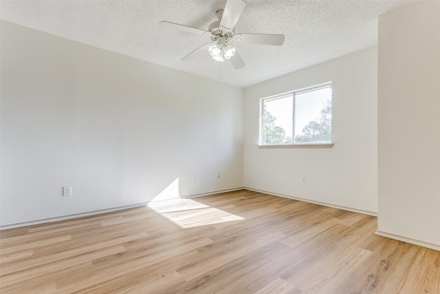 spare room featuring ceiling fan, light hardwood / wood-style flooring, and a textured ceiling