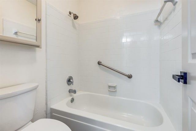 bathroom with tiled shower / bath combo and toilet