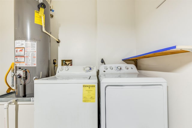 laundry area featuring washing machine and clothes dryer and water heater