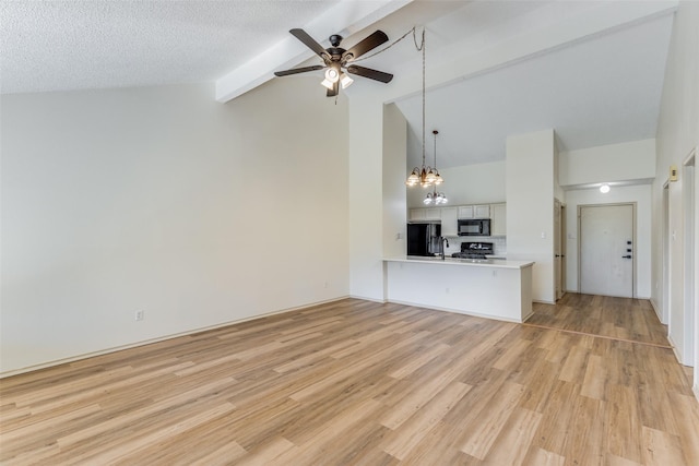 unfurnished living room featuring ceiling fan with notable chandelier, a textured ceiling, lofted ceiling with beams, and light hardwood / wood-style flooring