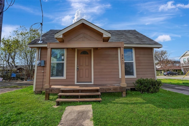 bungalow-style home with a front yard