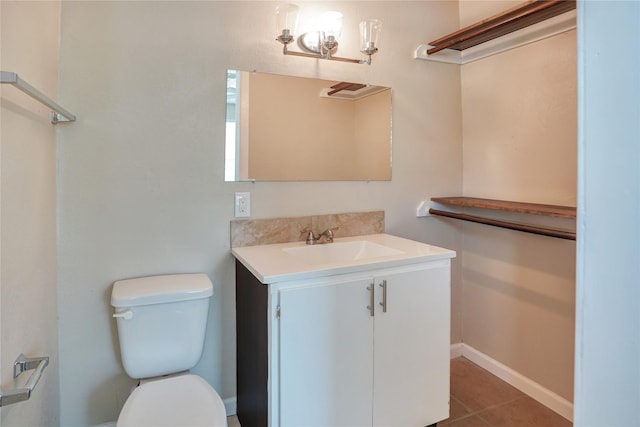 bathroom featuring tile patterned flooring, vanity, and toilet