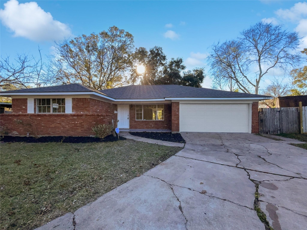 ranch-style house with a garage and a front yard