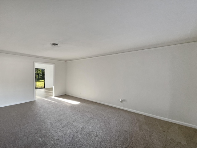 carpeted spare room featuring ornamental molding