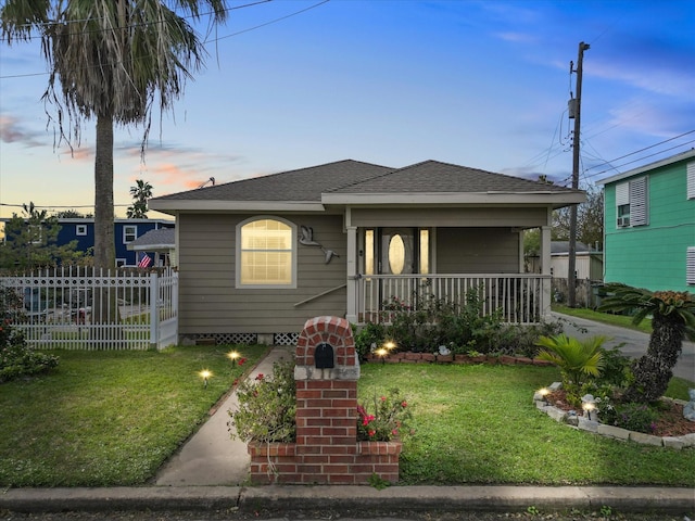 view of front of house featuring covered porch and a lawn