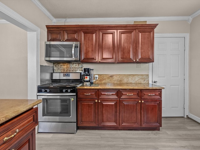 kitchen with light stone counters, light wood-type flooring, crown molding, and appliances with stainless steel finishes