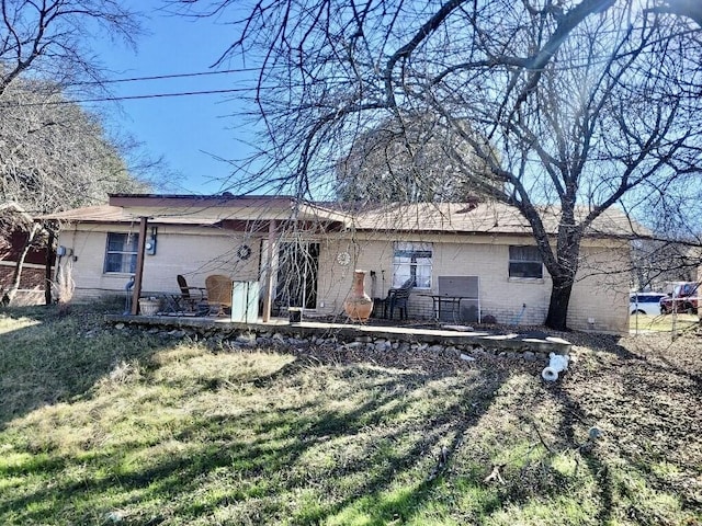 back of house featuring a patio area and a yard