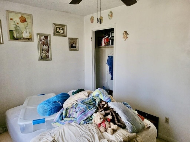 bedroom featuring ceiling fan and a closet