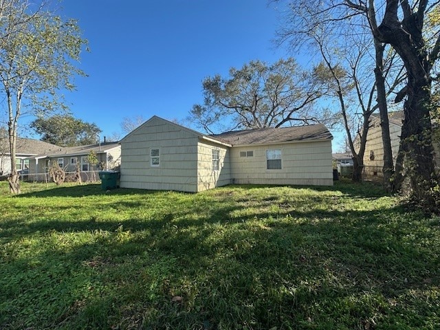 back of house with a lawn