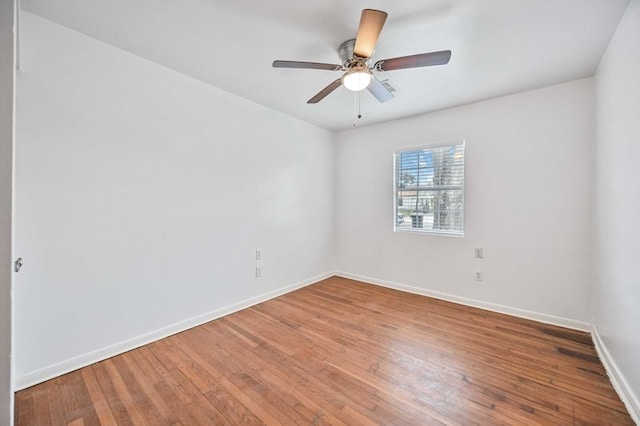 empty room featuring hardwood / wood-style flooring and ceiling fan