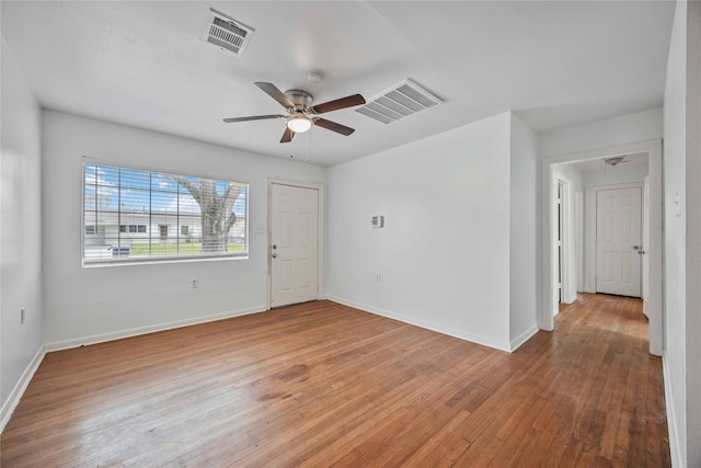 unfurnished room featuring hardwood / wood-style flooring and ceiling fan