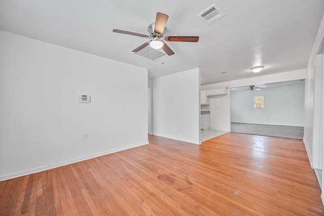 unfurnished living room featuring ceiling fan and light hardwood / wood-style floors