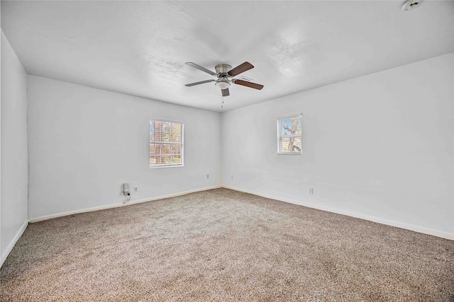 spare room featuring ceiling fan and carpet floors