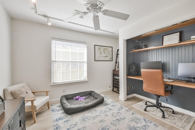 office featuring ceiling fan, rail lighting, and light wood-type flooring