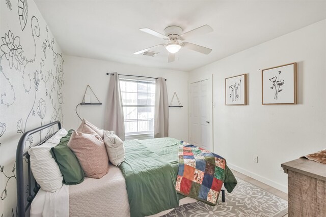 bedroom featuring hardwood / wood-style flooring and ceiling fan