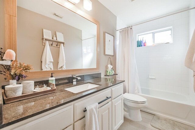 full bathroom with tile patterned flooring, vanity, shower / bath combo, and toilet