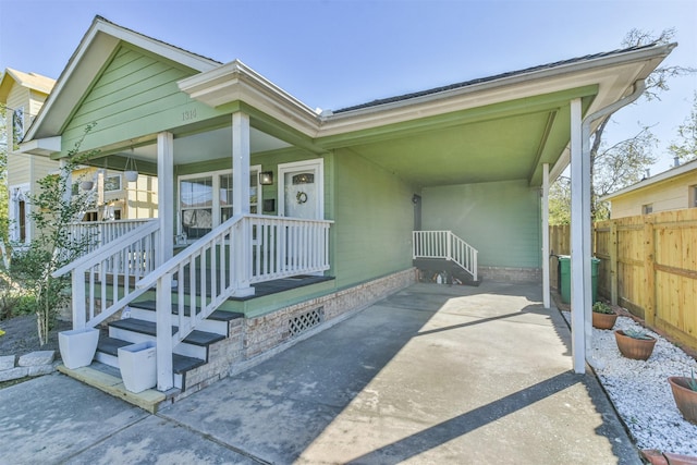 entrance to property with a porch and central AC unit