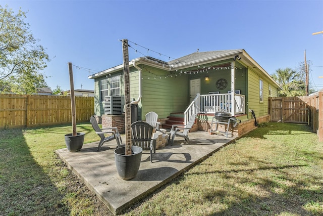 back of property featuring a lawn and a patio