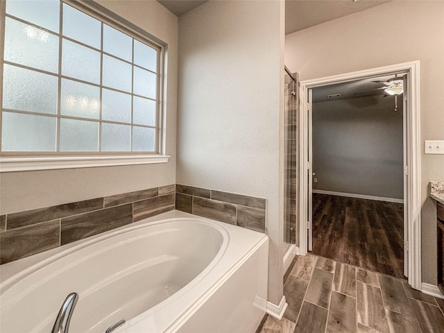 bathroom with vanity, plus walk in shower, and a wealth of natural light