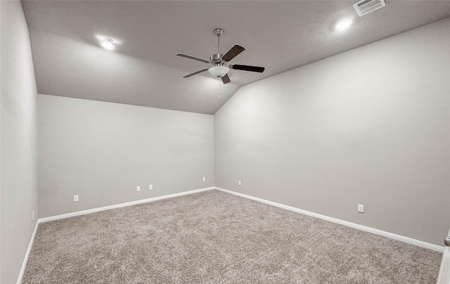 carpeted empty room featuring ceiling fan and lofted ceiling