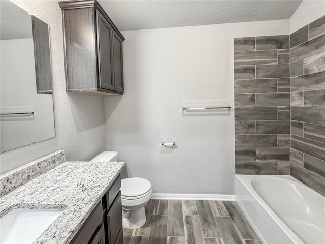 full bathroom with shower / washtub combination, vanity, a textured ceiling, and toilet