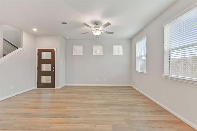 foyer with ceiling fan and light wood-type flooring