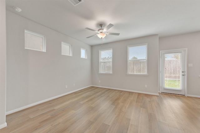 empty room featuring ceiling fan and light hardwood / wood-style floors