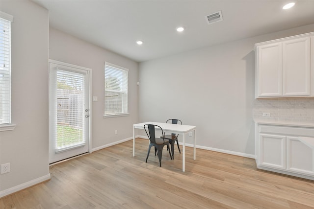 dining space with light hardwood / wood-style floors and a wealth of natural light