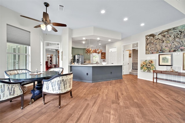 dining space with light hardwood / wood-style floors and ceiling fan