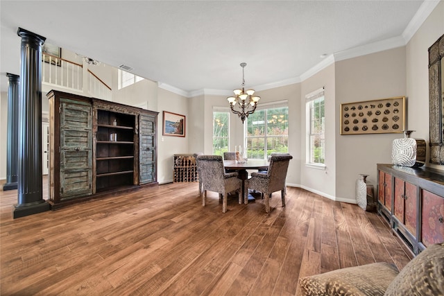 dining area with crown molding, plenty of natural light, a chandelier, and hardwood / wood-style flooring